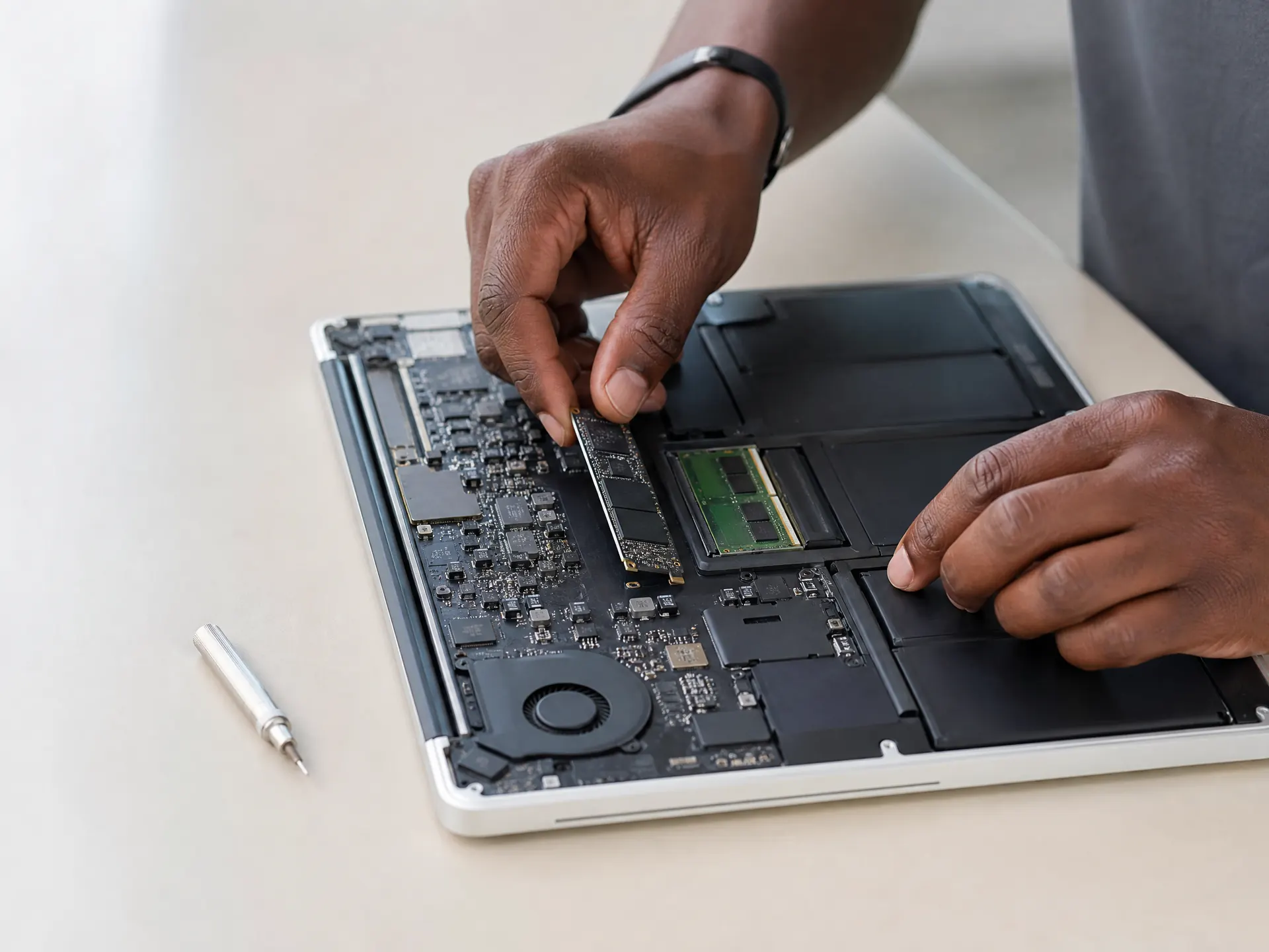 Laptop technician installing an internal hardware upgrade