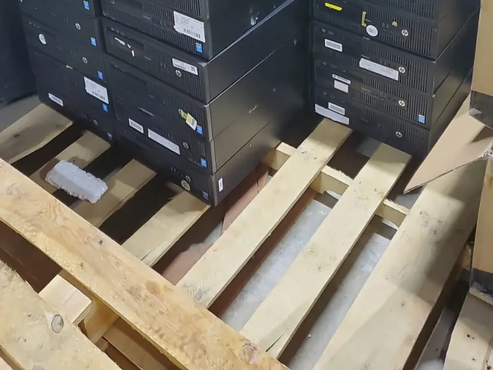 Stacked refurbished desktop computer towers ready for an office order